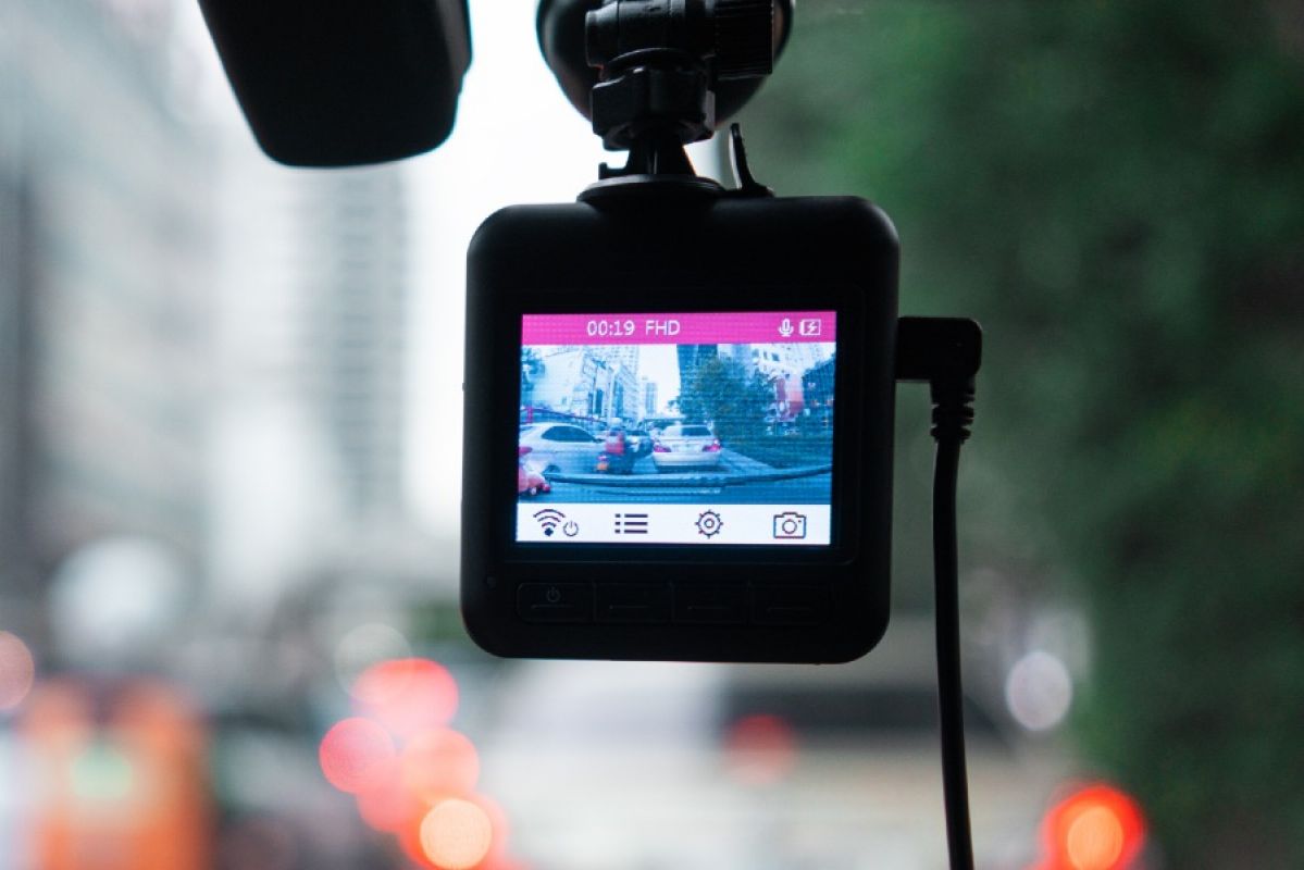 view of dashcam, with cars seen through the screen