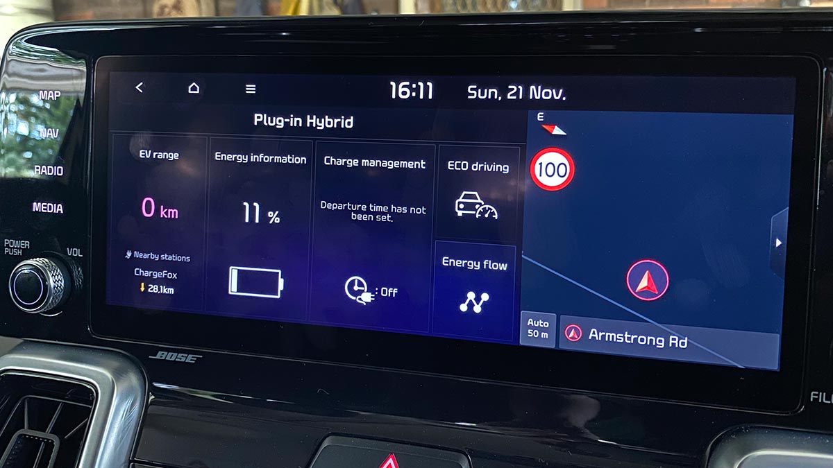 Centre dash display of Kia Sorento PHEV showing 0km driving range and 11% battery charge.