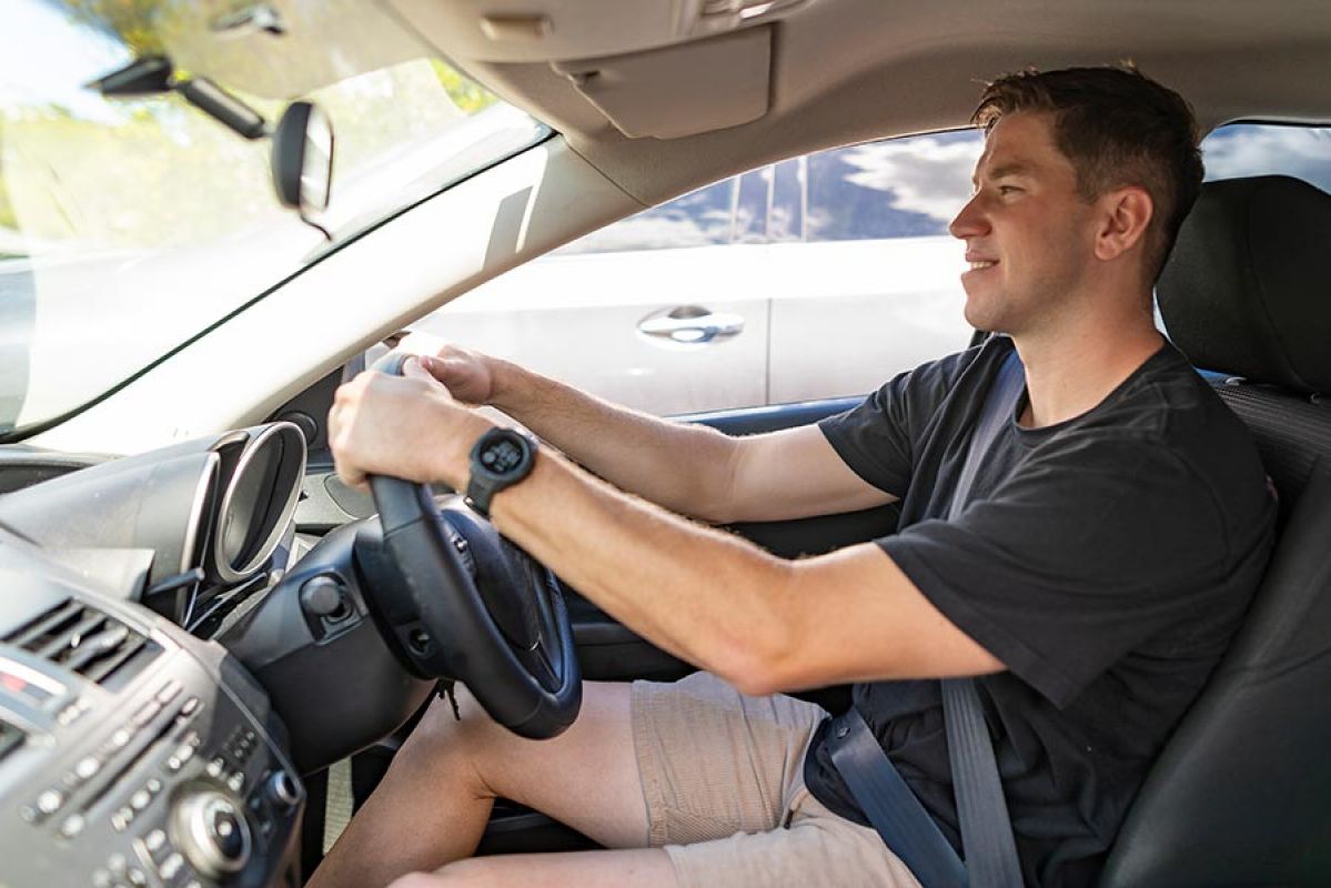 Young man driving car in Australia.