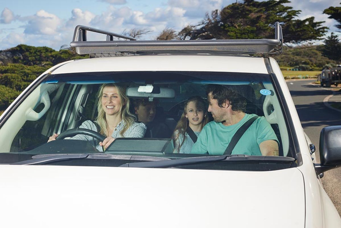 man driving his car and smiling