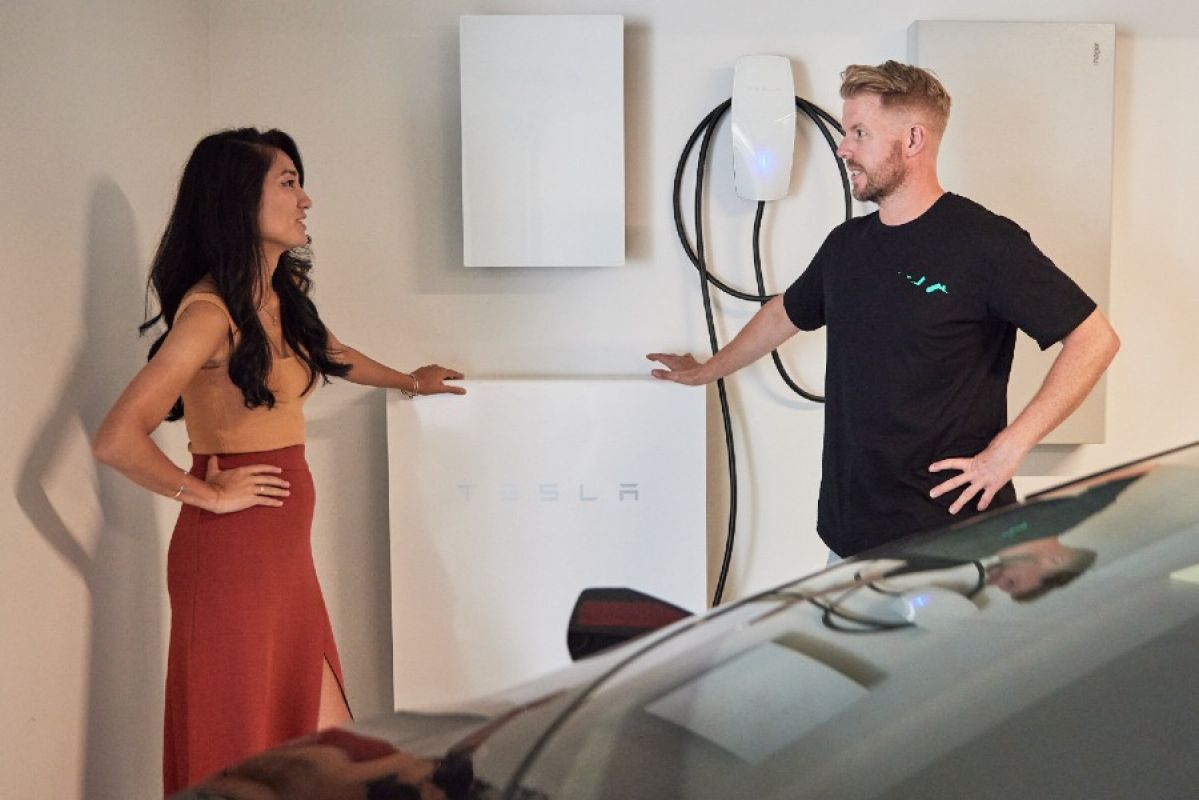 woman and man talking in front of a home EV charger