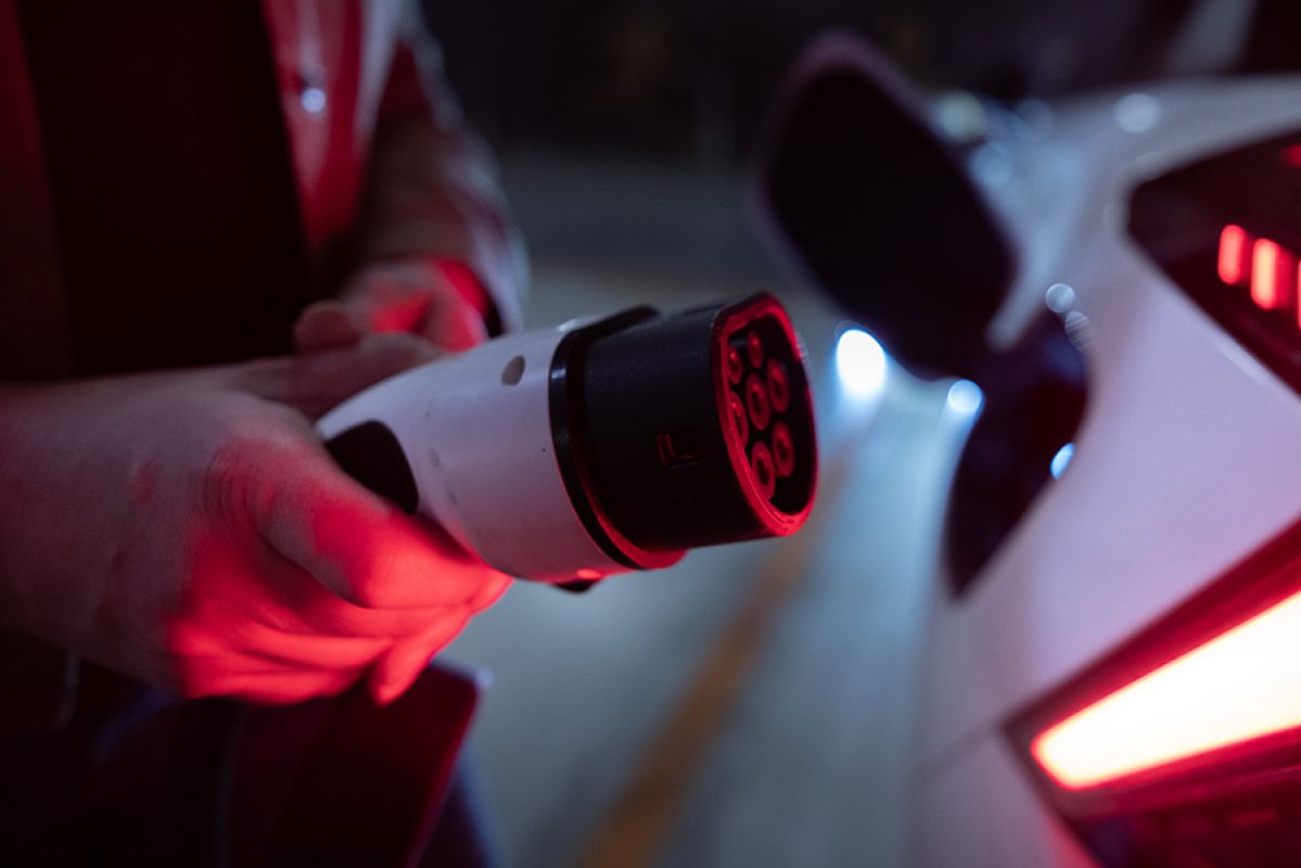 Close-up of brightly lit MG4 EV being recharged in underground car park