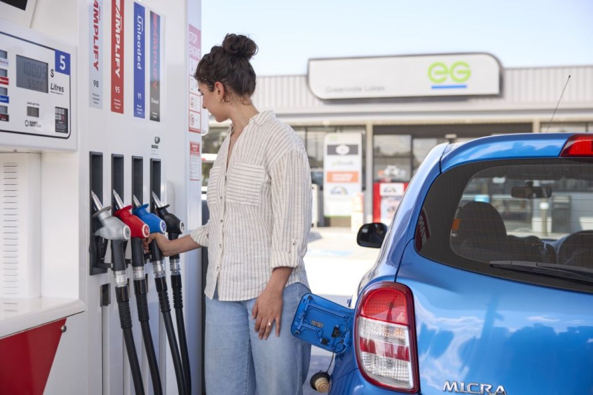 young woman fuelling her car