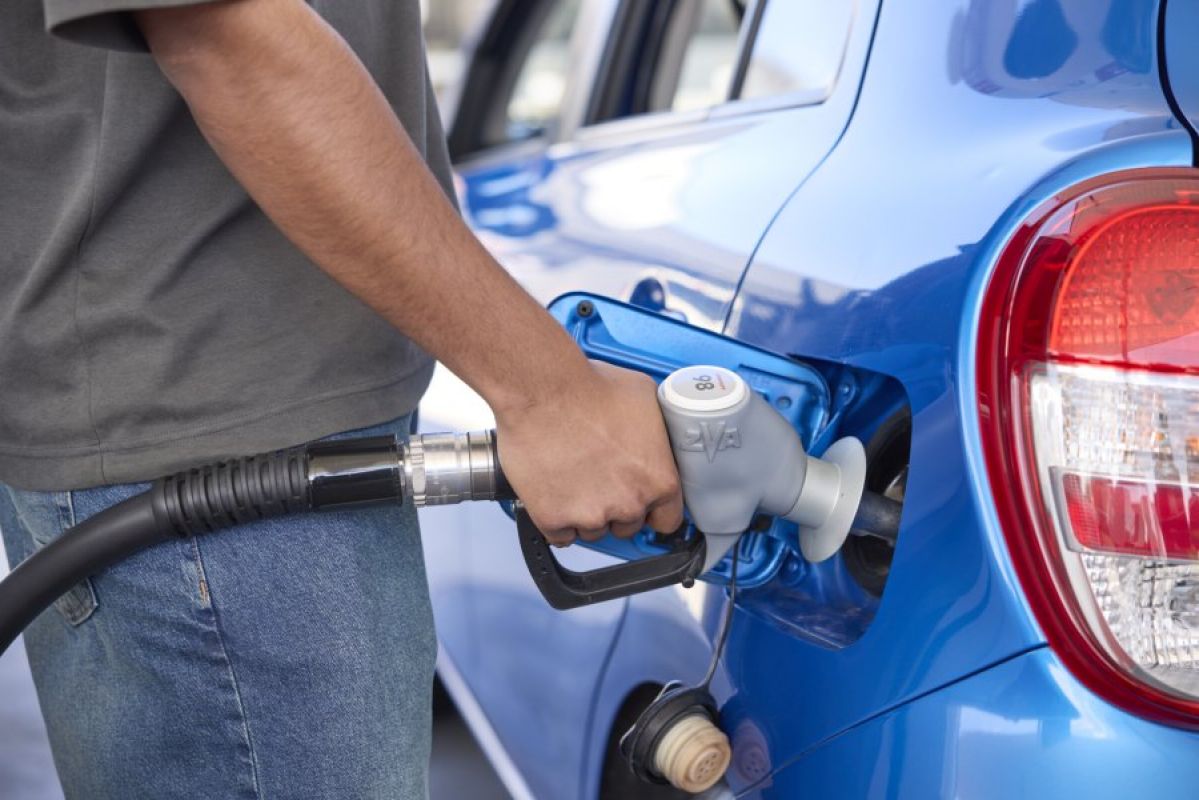 young man fuelling his car at a petrol pump