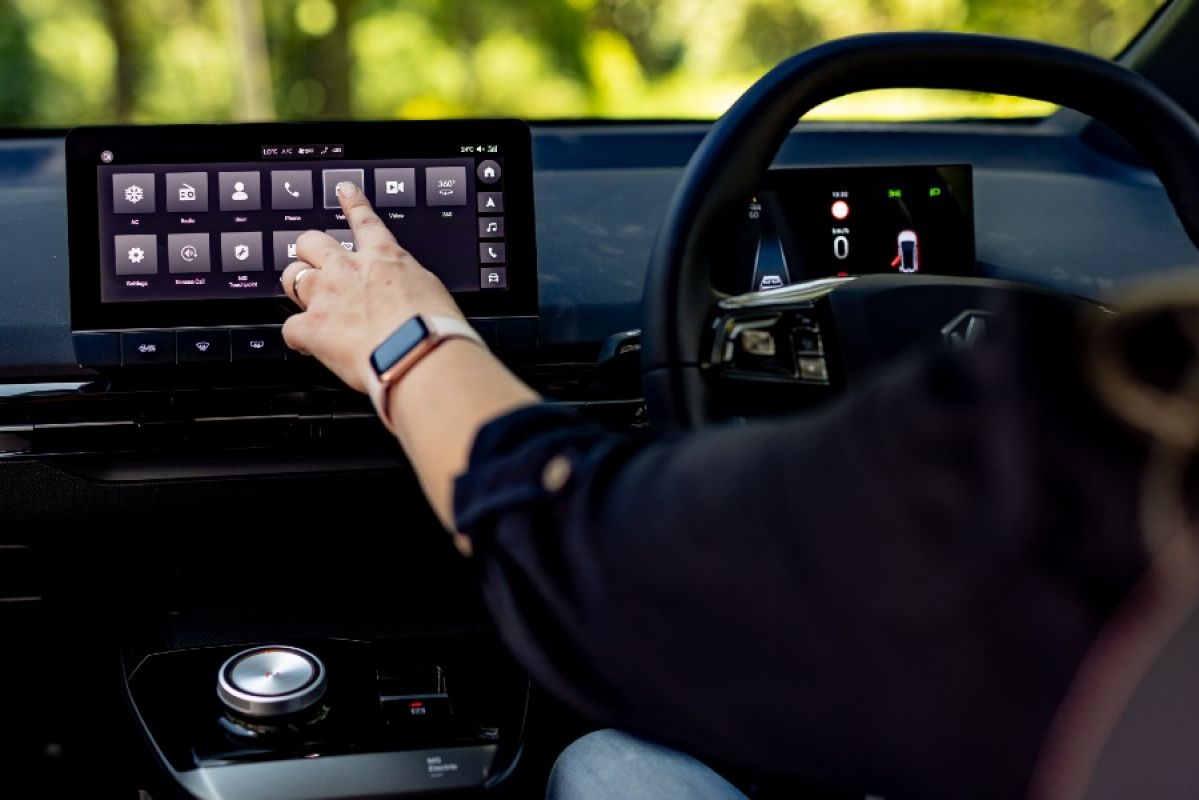 woman touching car infotainment screen