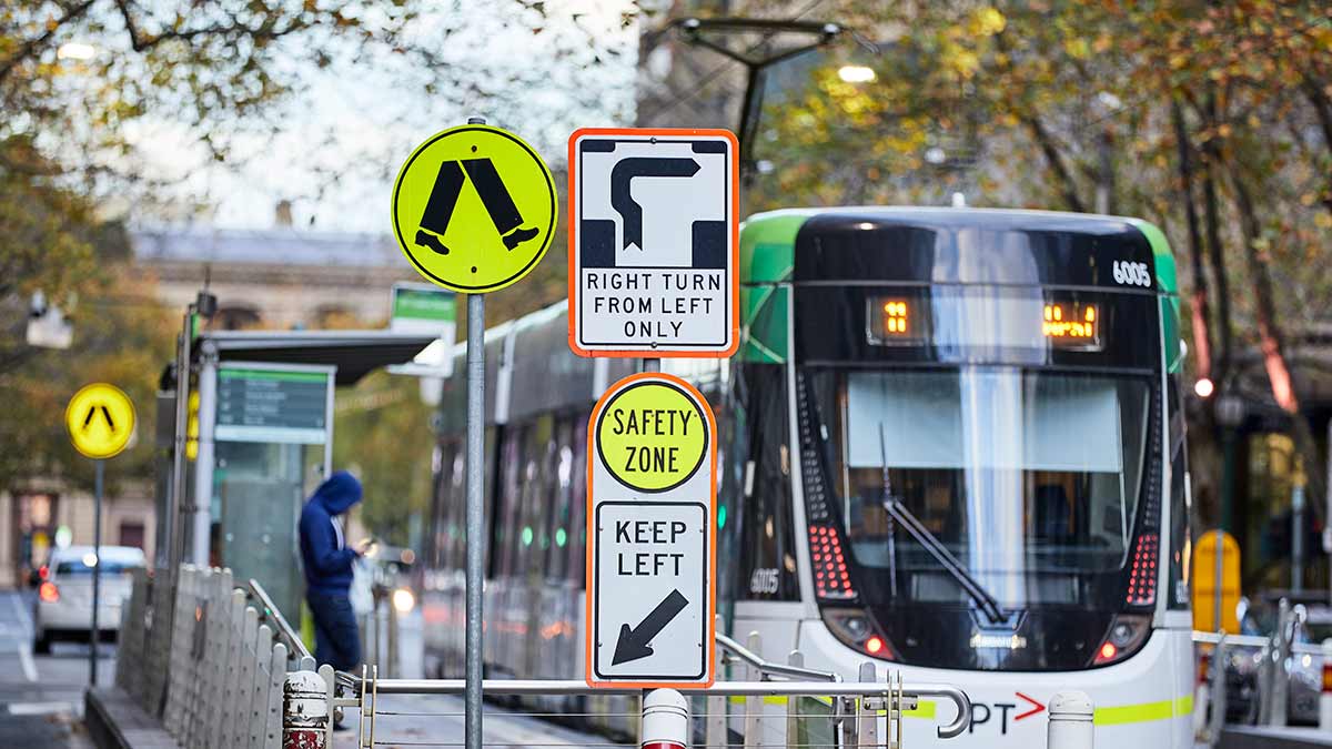 Tram at stop in Melbourne's CBD.