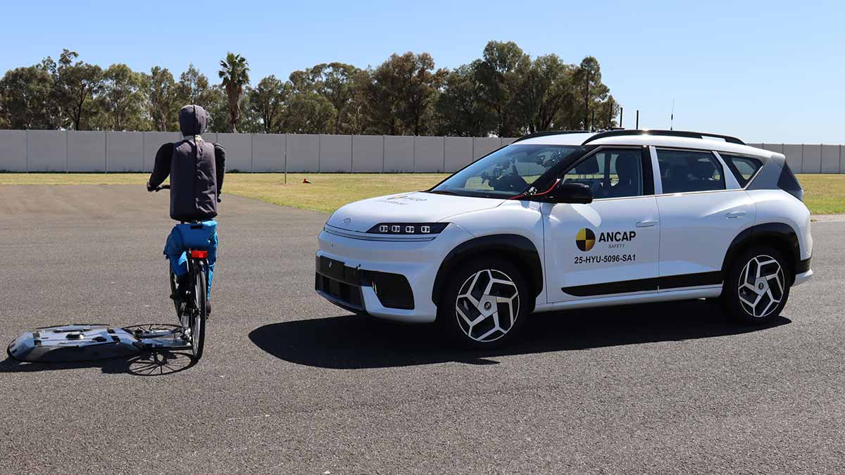 ANCAP autonomous braking safety testing of white Hyundai Elexio SUV in front of dummy cyclist.