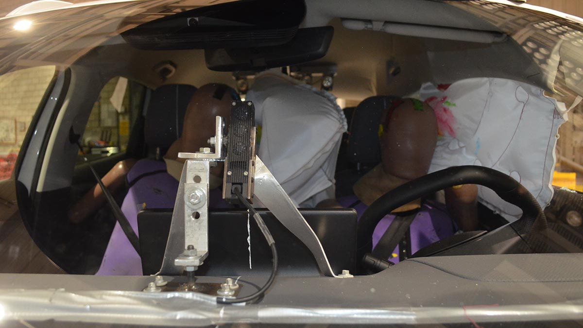 Close-up of crash test dummies hitting airbags in side impact test with MG S5 EV.