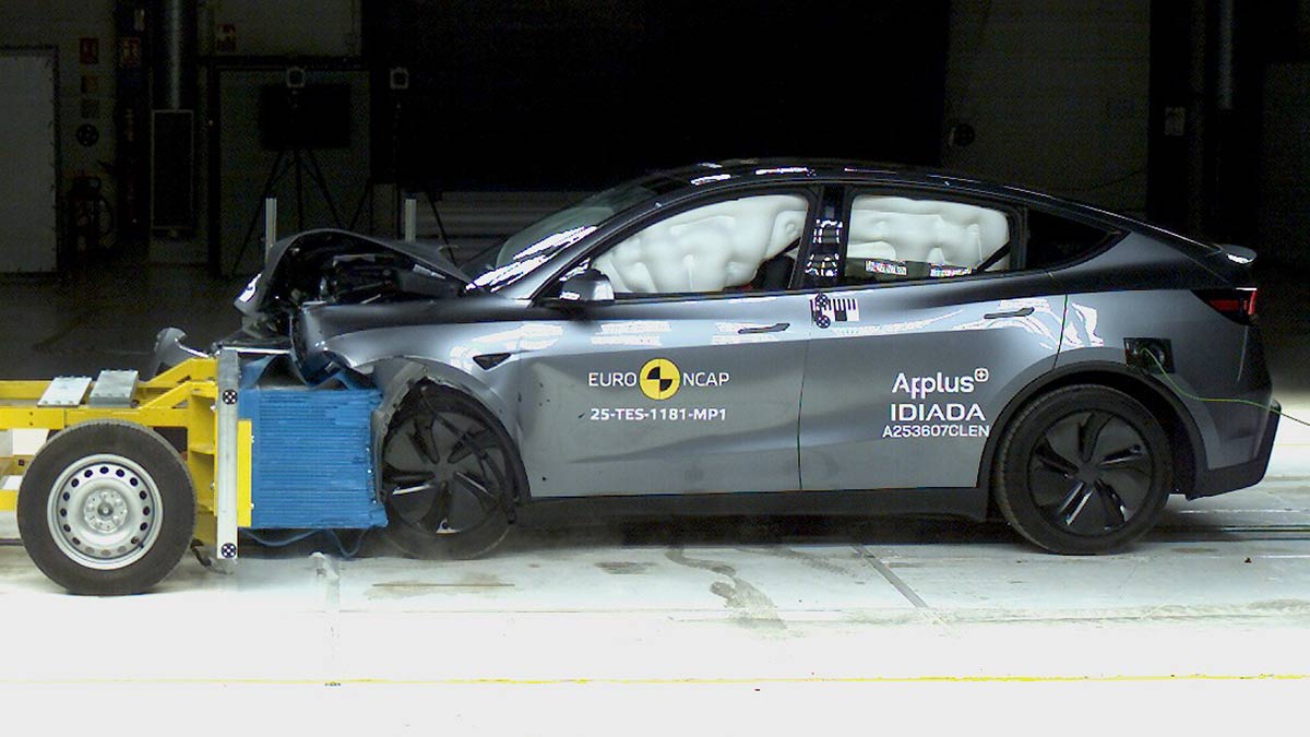 Light metallic Tesla Model Y SUV crashing into barrier in Euro NCAP frontal offset test.