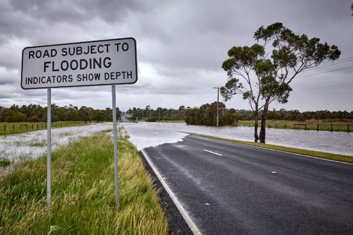 flooded road with road sign saying Road subject to flooding