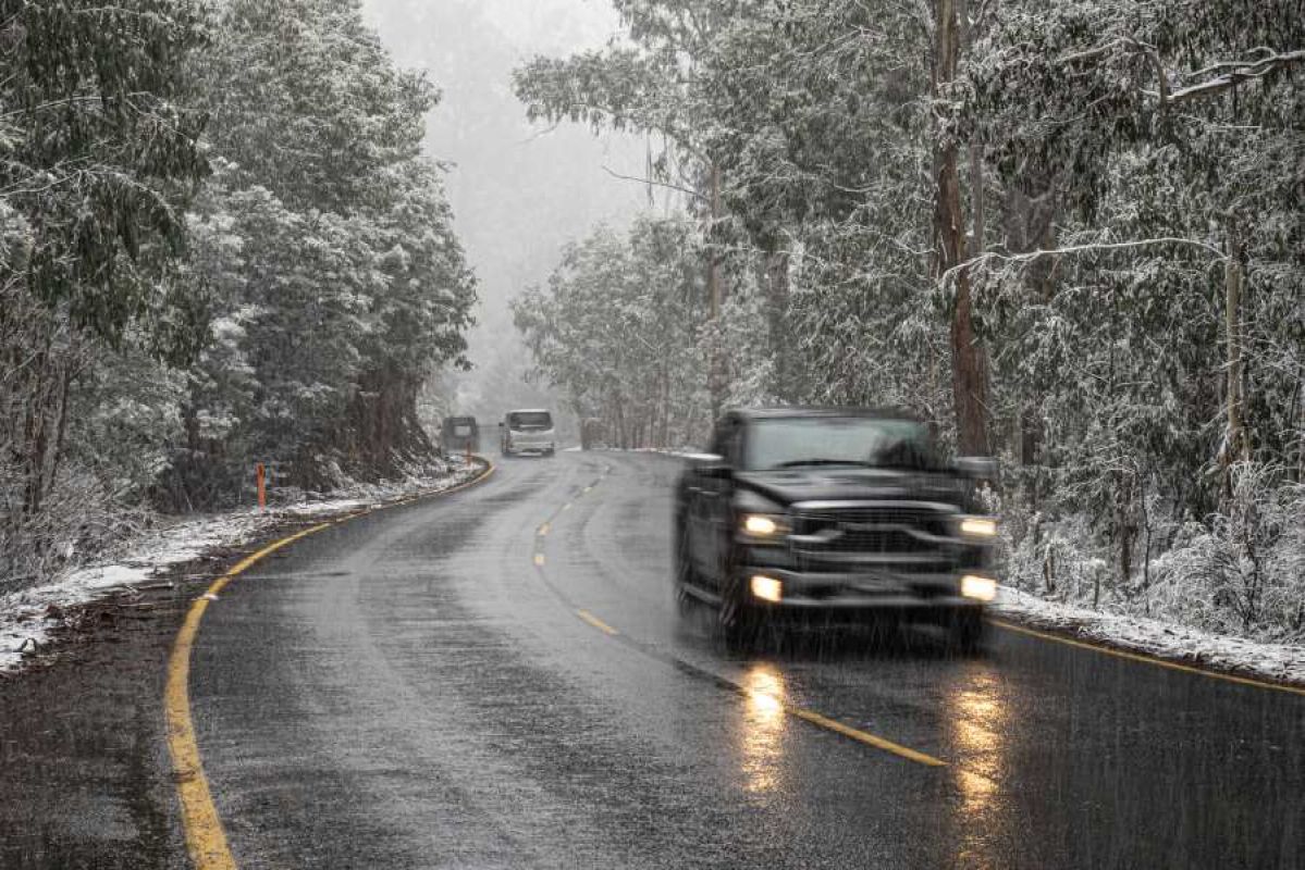 cars driving on wet, snowy, icy road