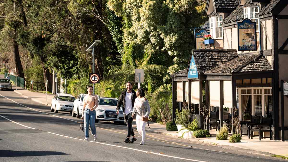 Three people crossing road from Miss Marple's Tearoom, Sassafras