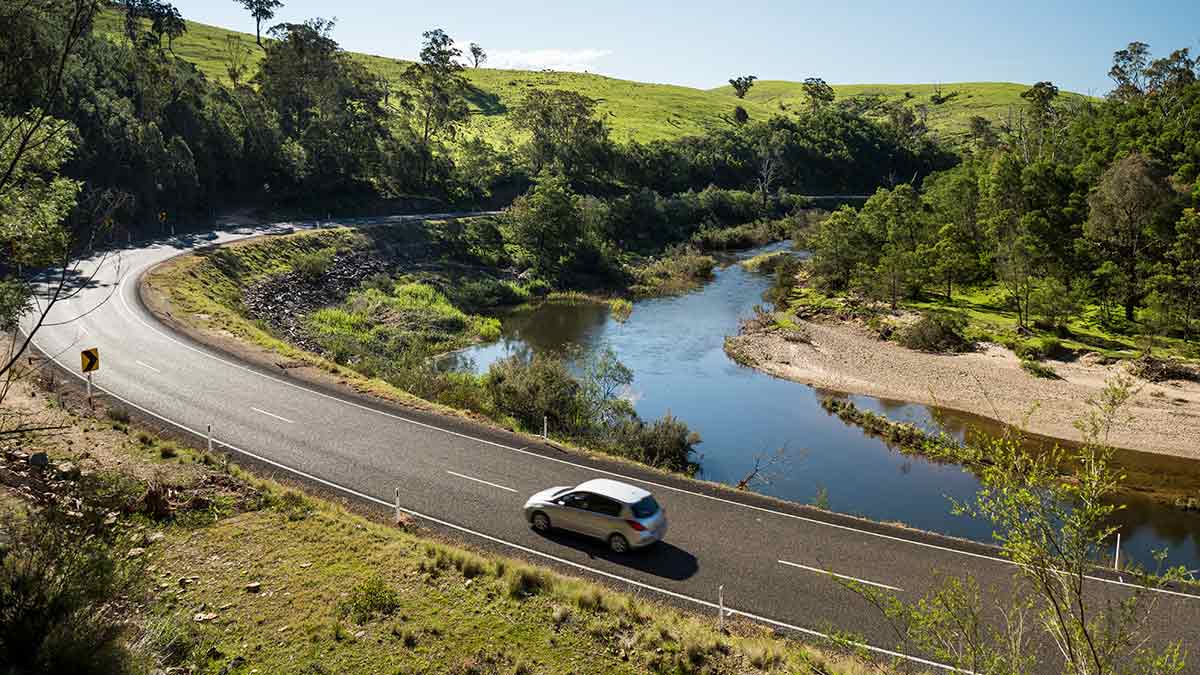 Car driving on Great Alpine Road next to Tambo River