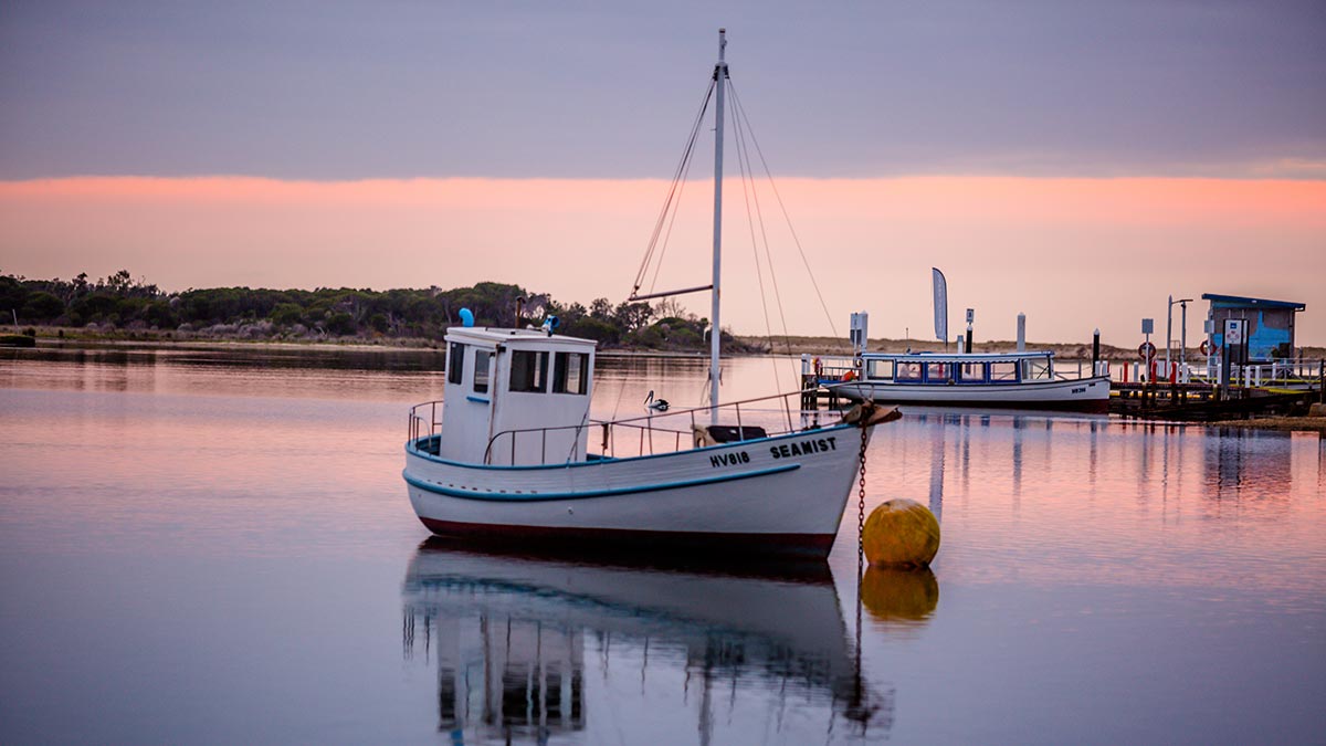 Boat on water at sunset at Mallacoota