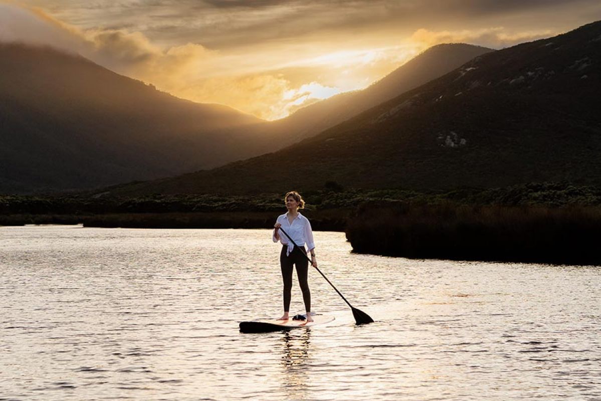 Woman paddle boarding on Tidal River at Wilsons Promontory