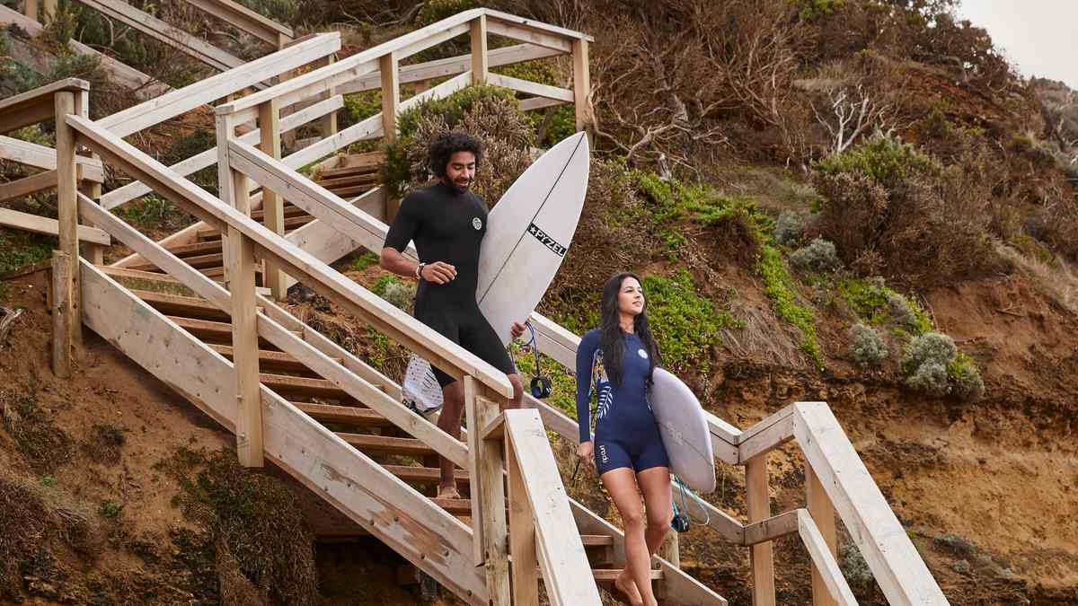 Two people with surfboards