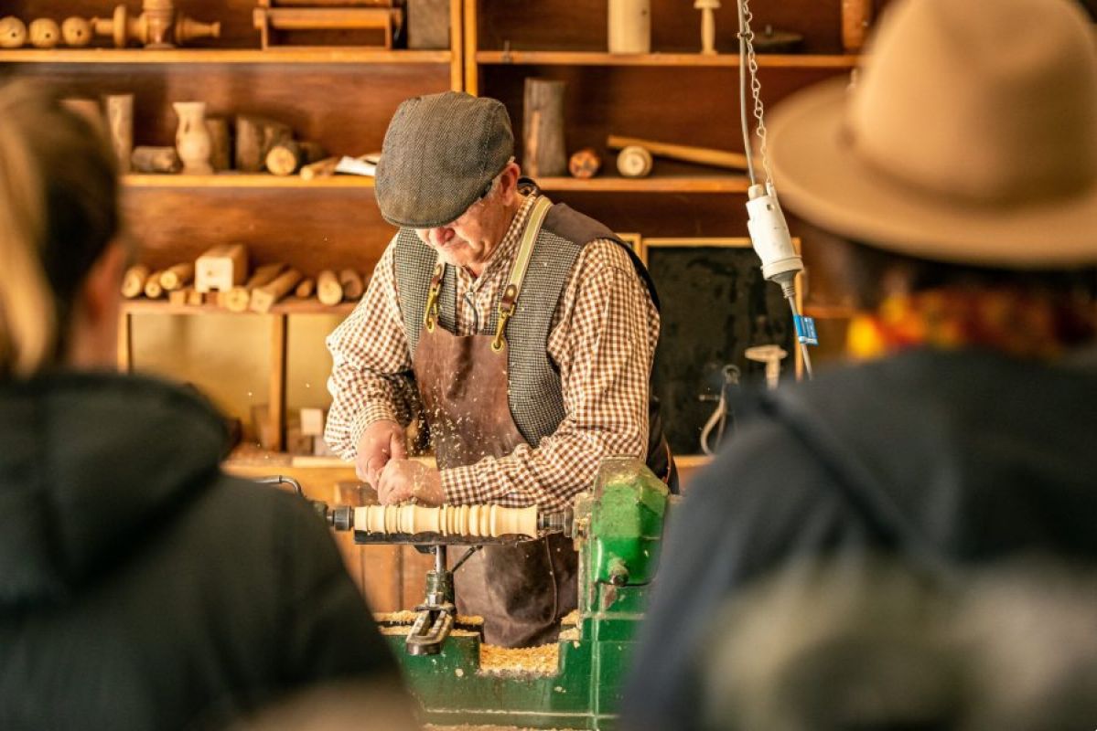 two people watching a woodturning demonstration