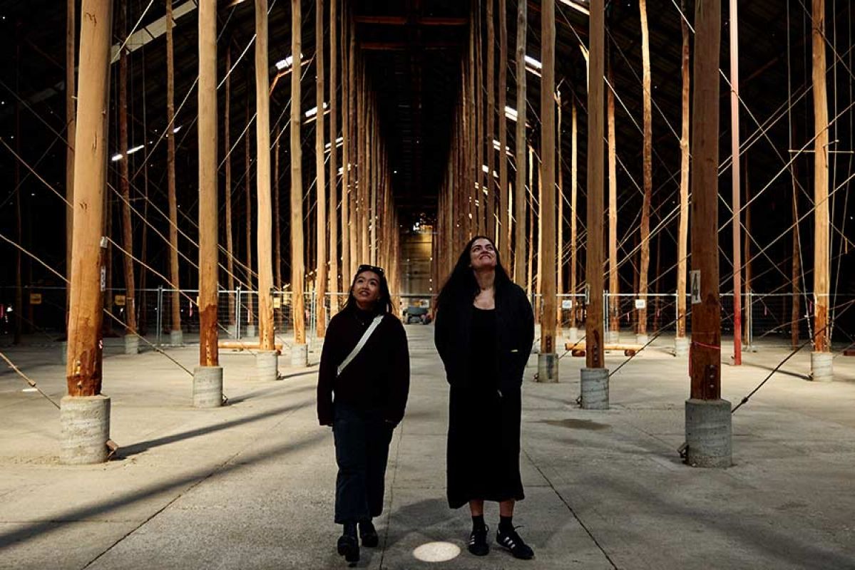 two women in shed with towering poles