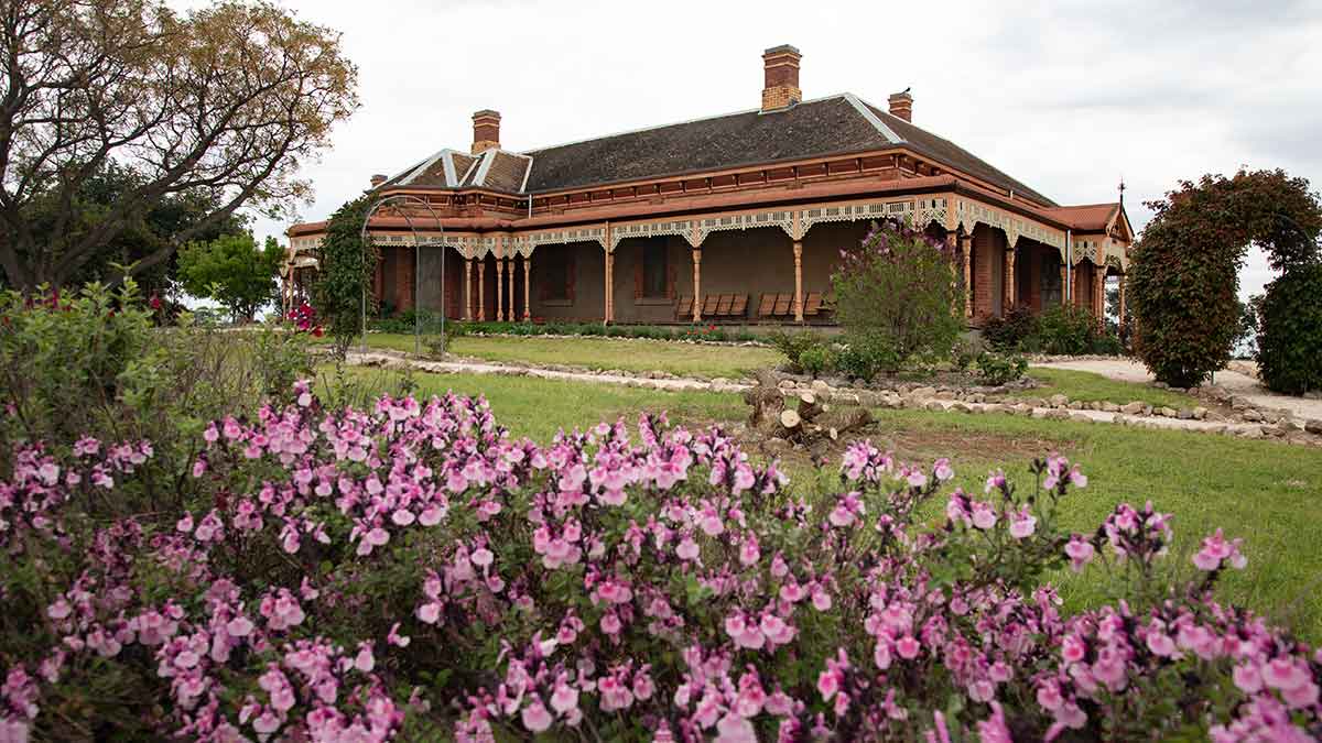 historic homestead with garden in foreground