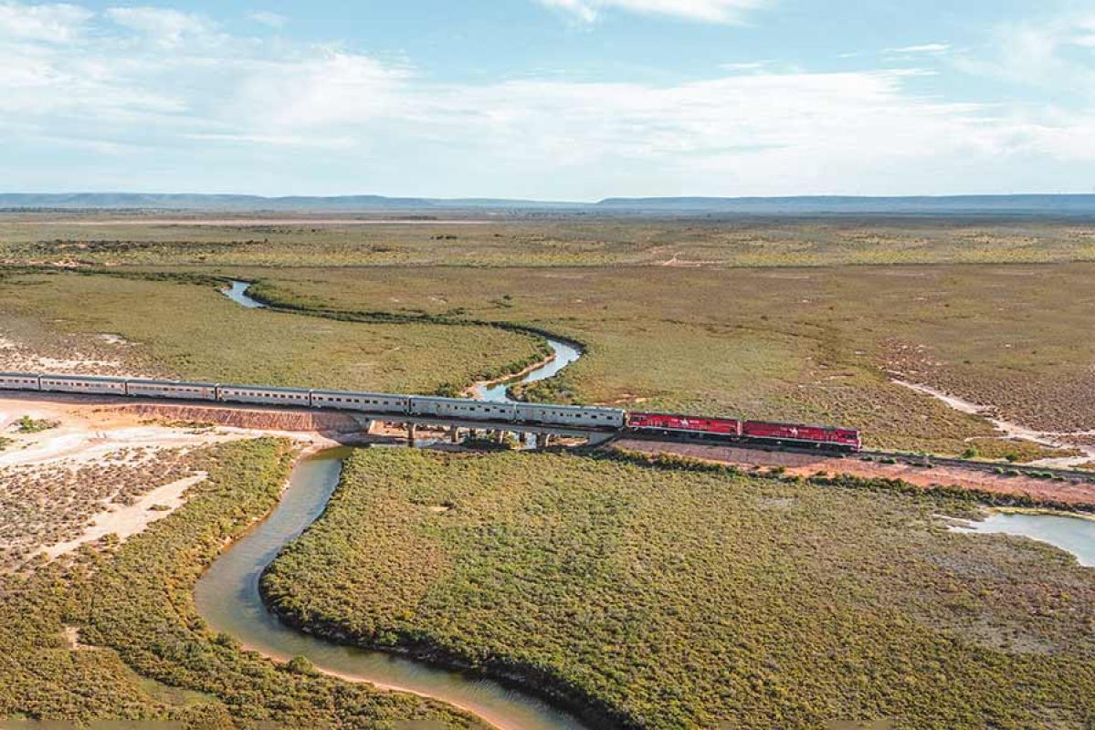 red train crossing river in Flinders Ranges area
