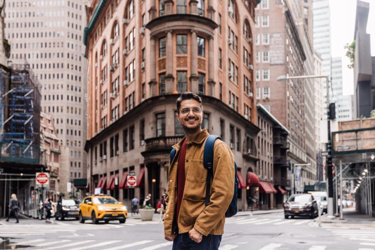 man standing smiling in NYC