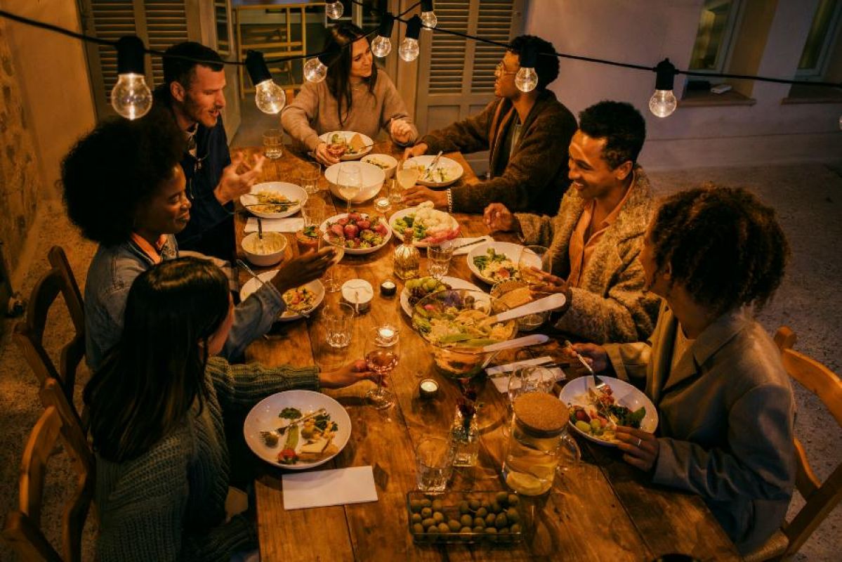 seven people enjoying a candlelit meal