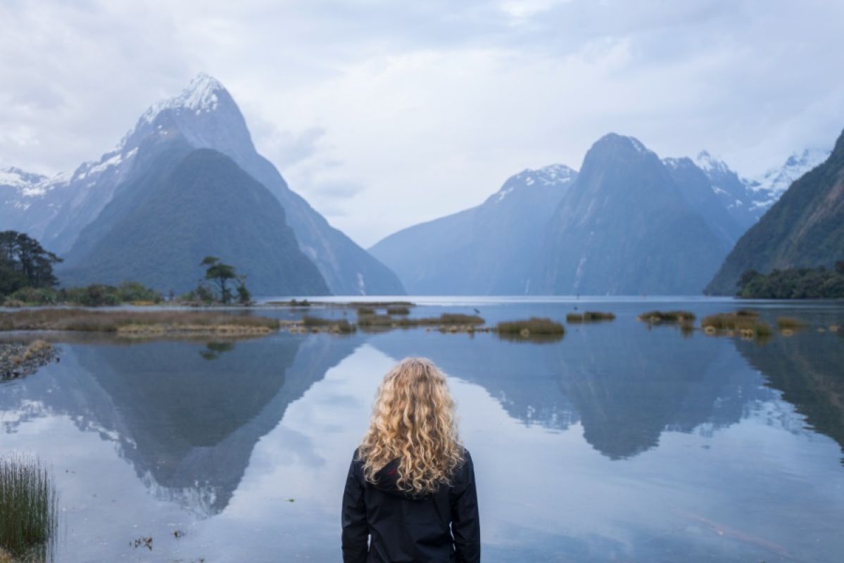 woman looking at Milford Sound