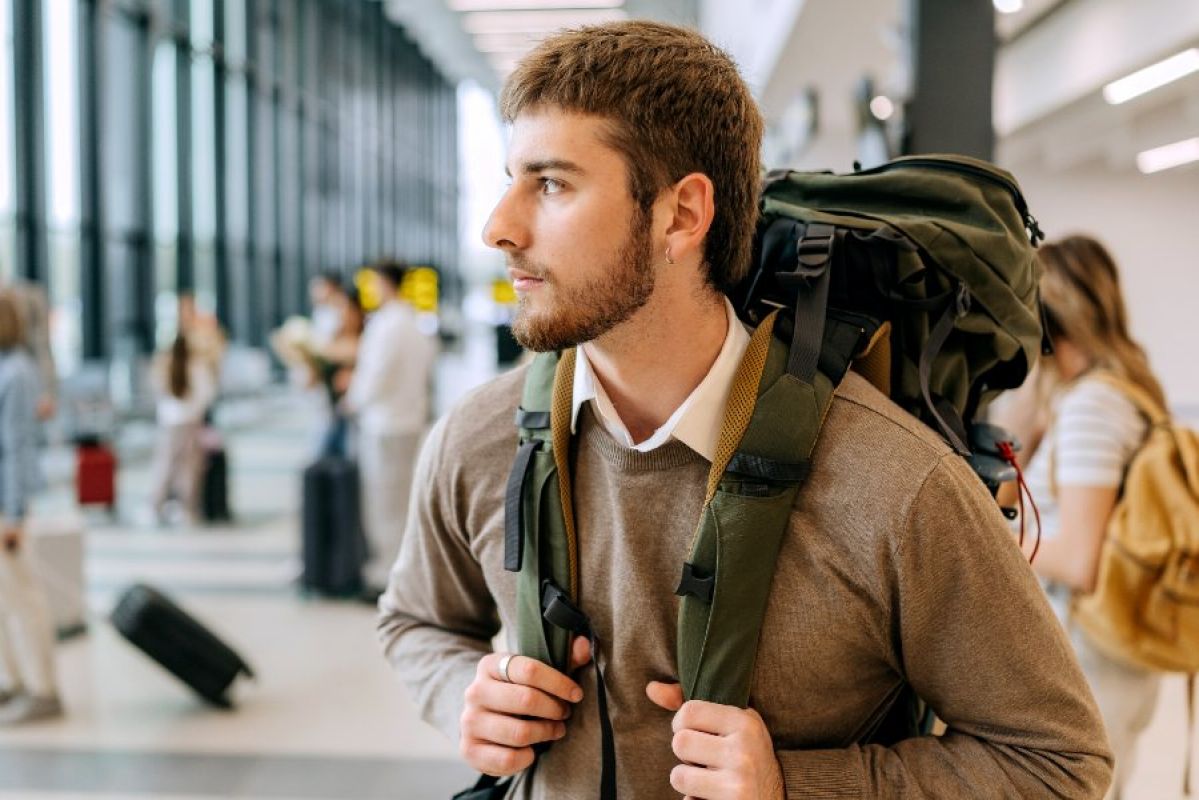 young male backpacker at airport