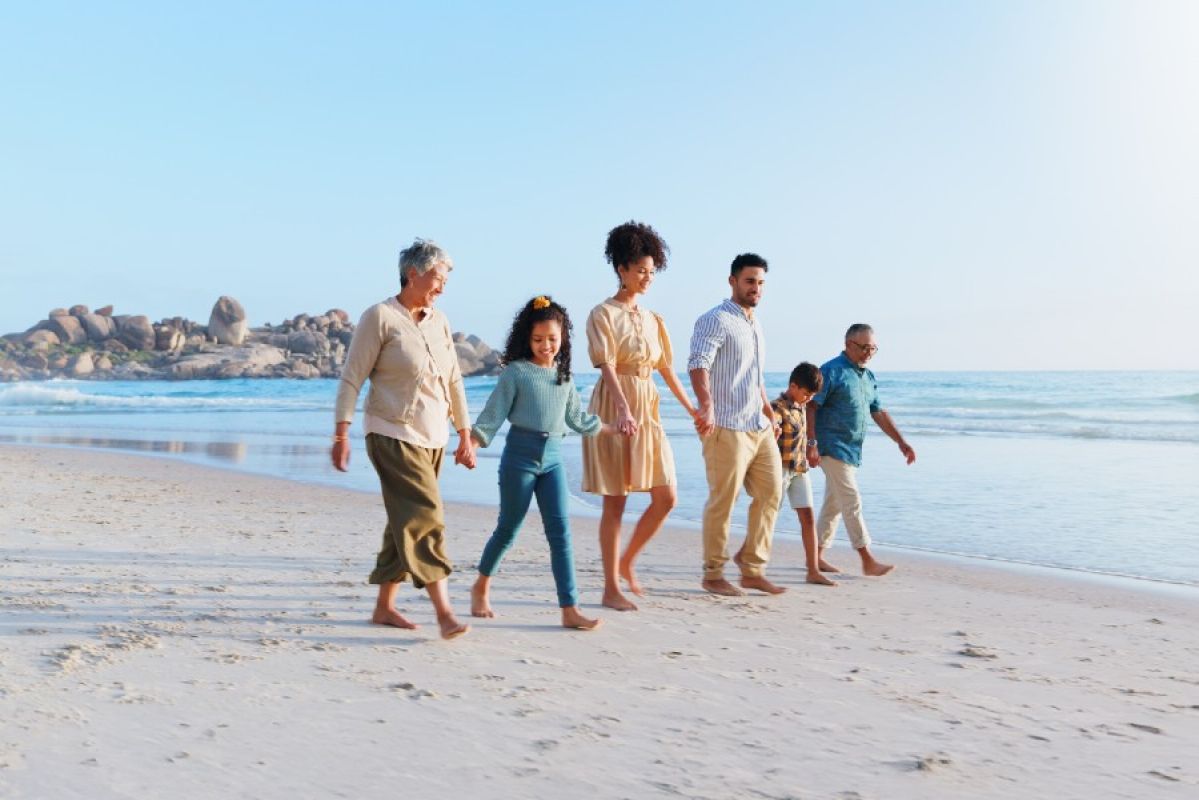 multi-generational family walking on beach