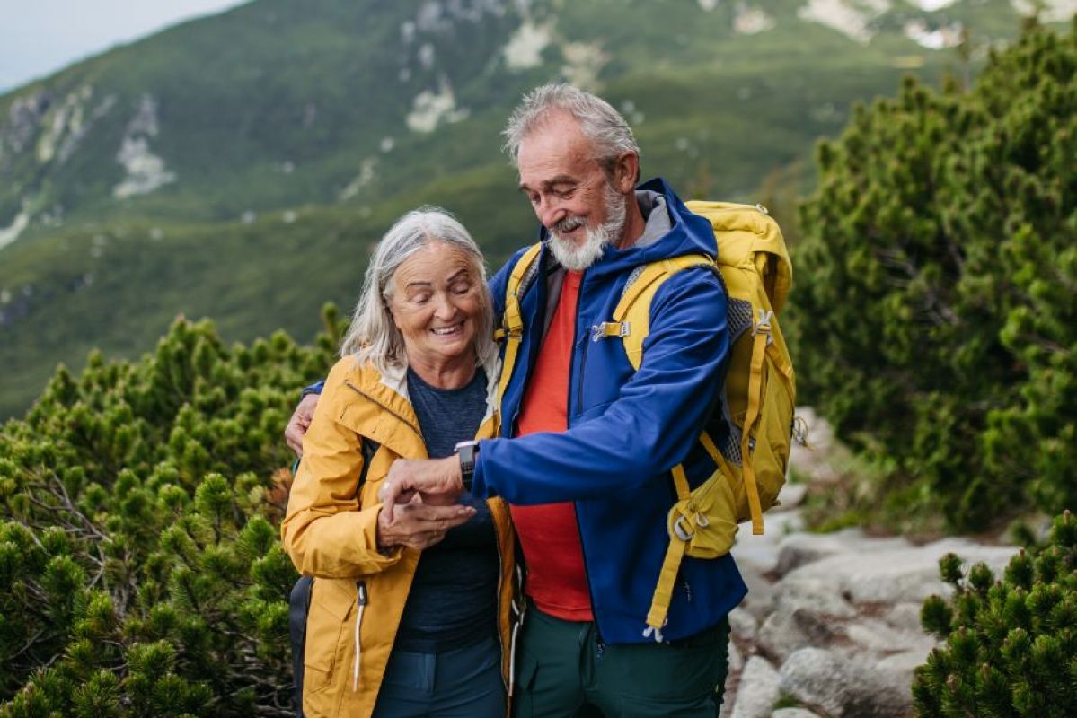 senior couple hiking in forested mountains
