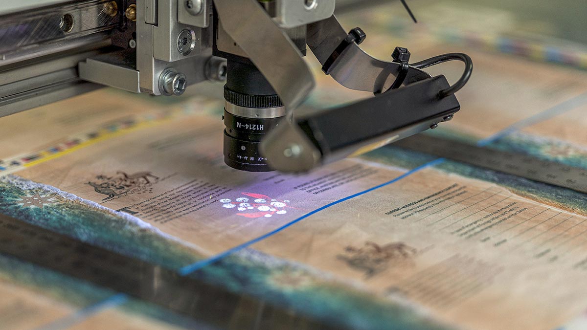 Australian passport in print production process, showing security markings under UV light