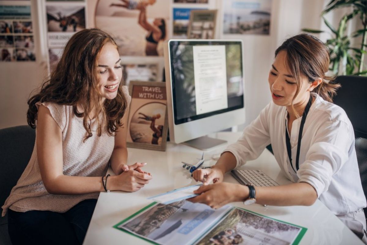 travel agent showing client travel information