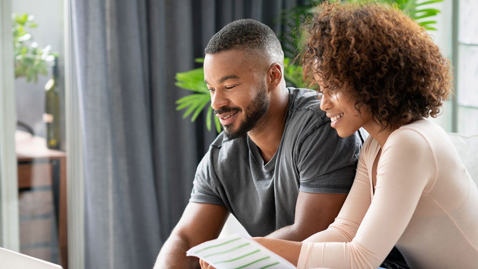 A couple infront of a computer discussing their finances.
