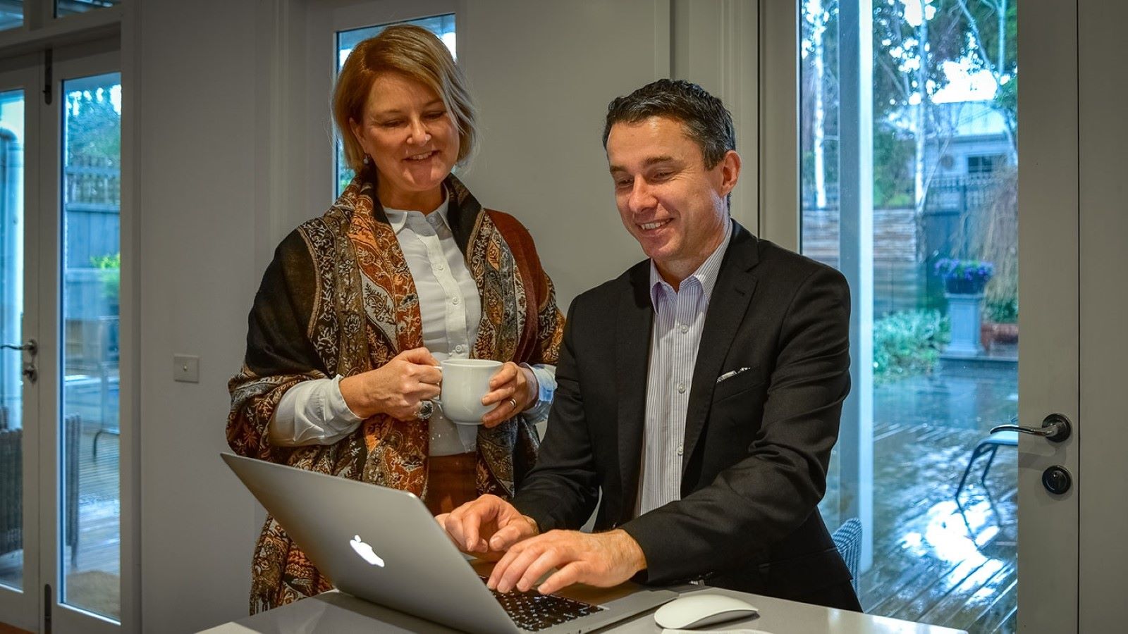 A couple reviewing debt consolidation loans in front of a computer