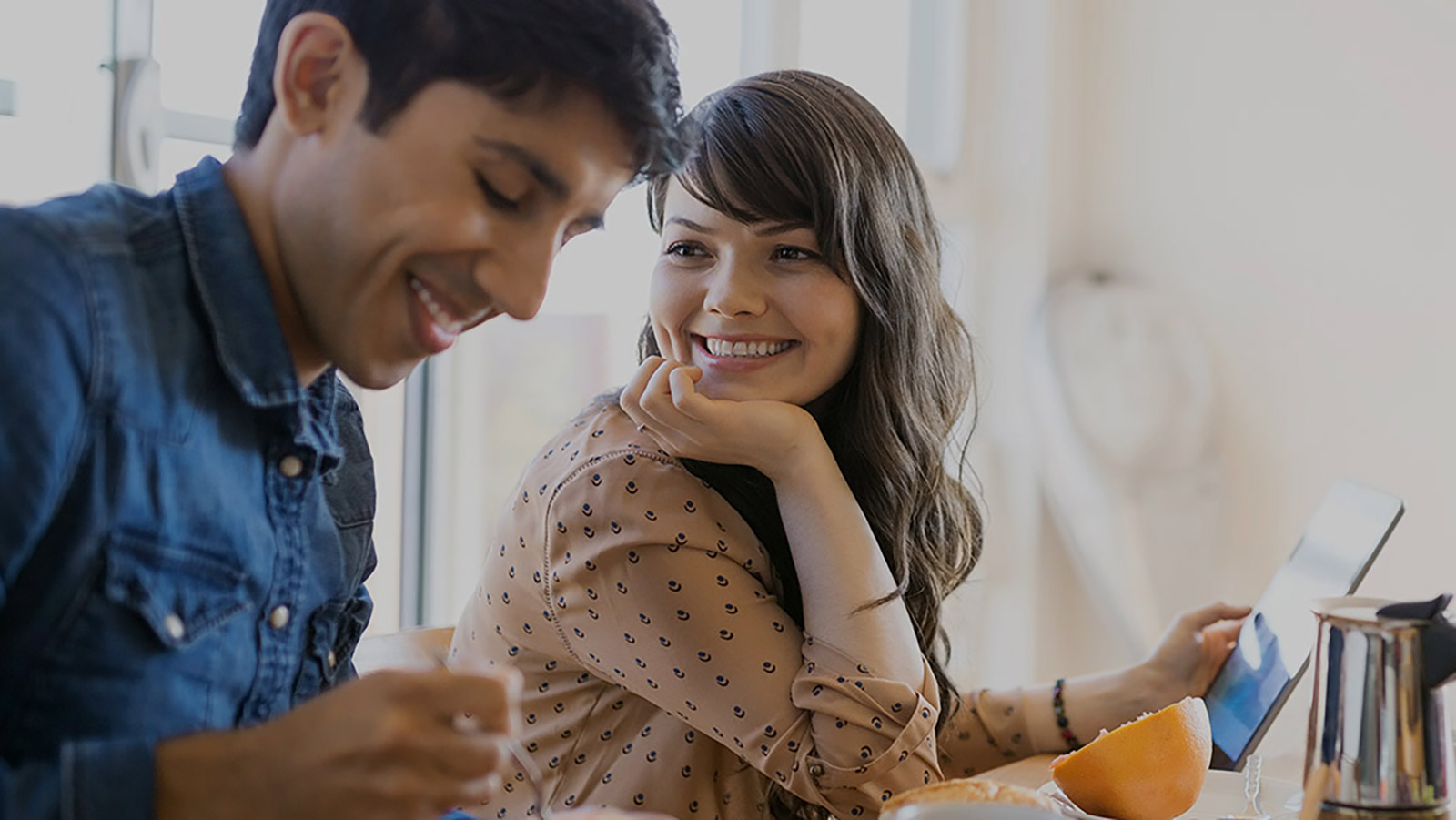 Couple smile at the opportunity to buy a new house