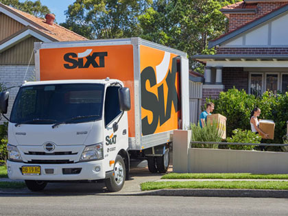 SIXTY moving truck parked in a driveway