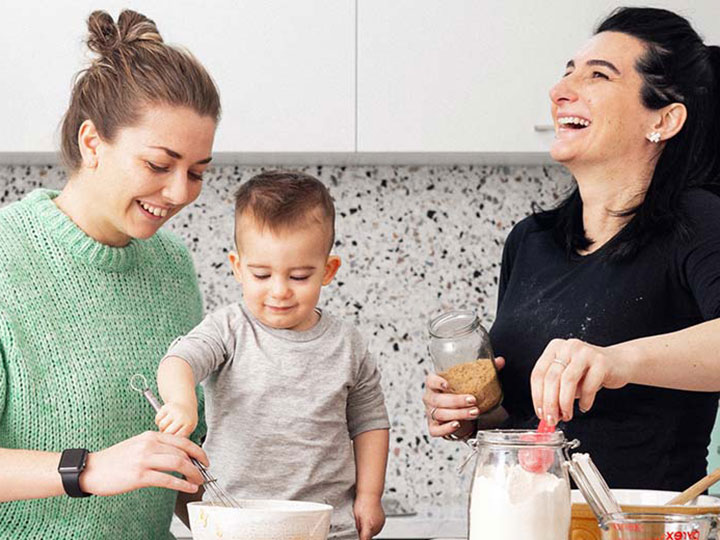 two women cooking with baby