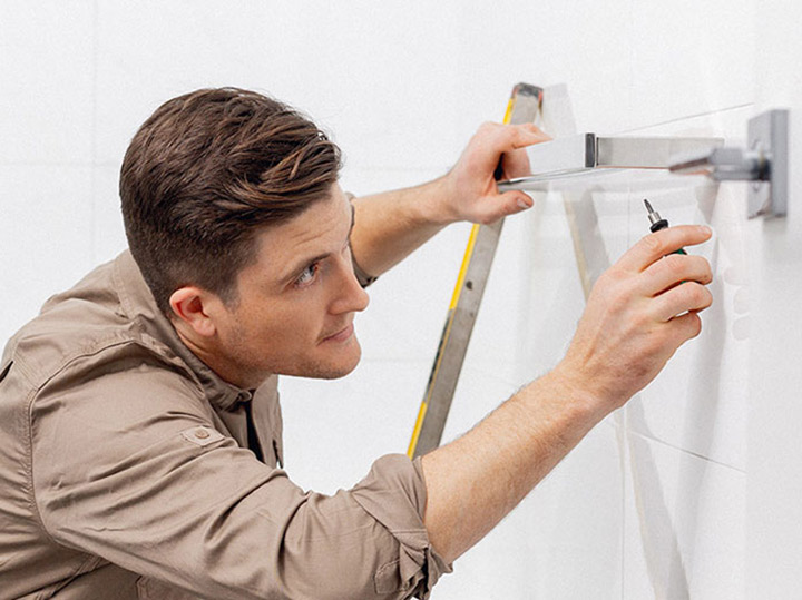 Man works on improving his home prior to selling it