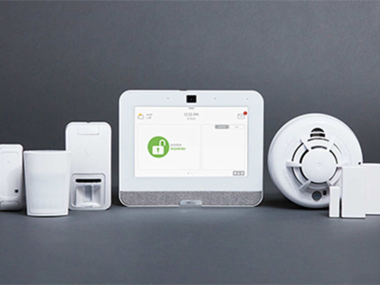 White smart home security setup including a tablet and sensors.