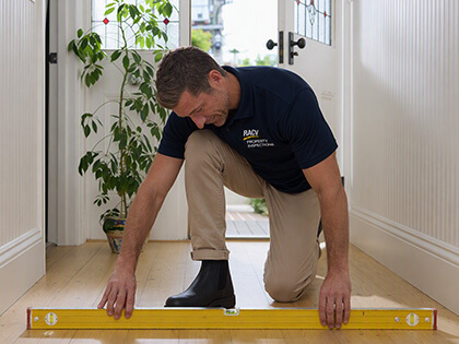 RACV inspector measuring floor.