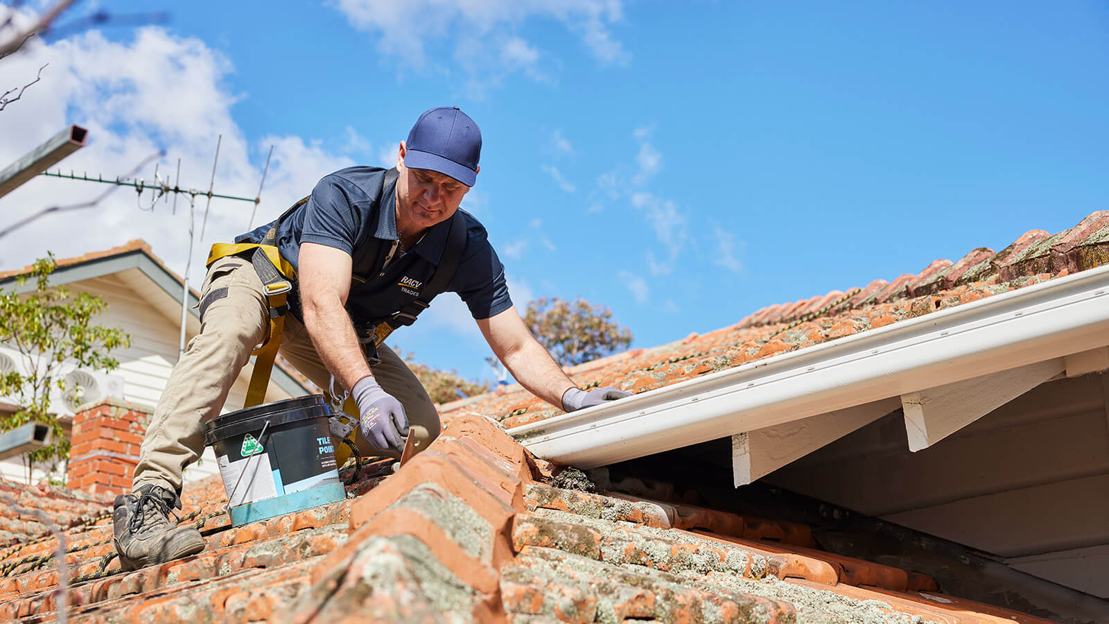 RACV tradie working on a tiled roof.