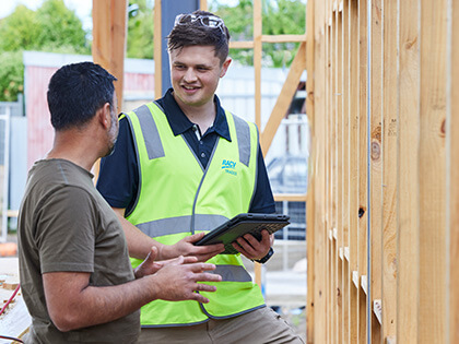 RACV tradie speaking to a customer on site.