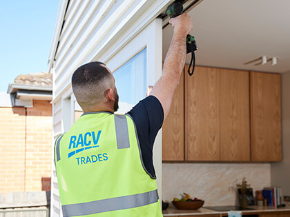 RACV tradie drilling a sliding door.