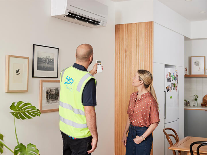 RACV tradesperson turning on a spit system for a customer.