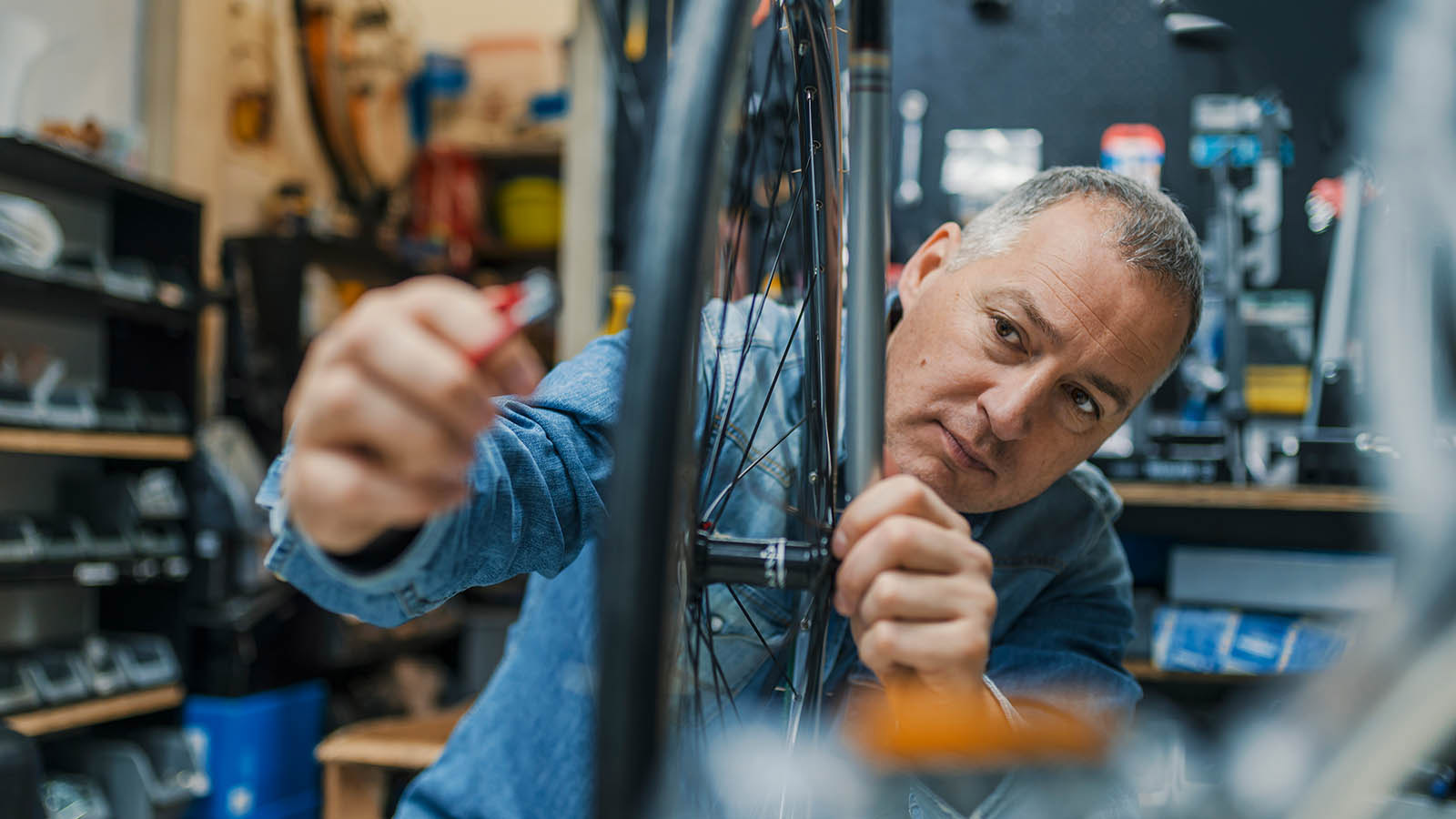 A man repairing a bicycle.