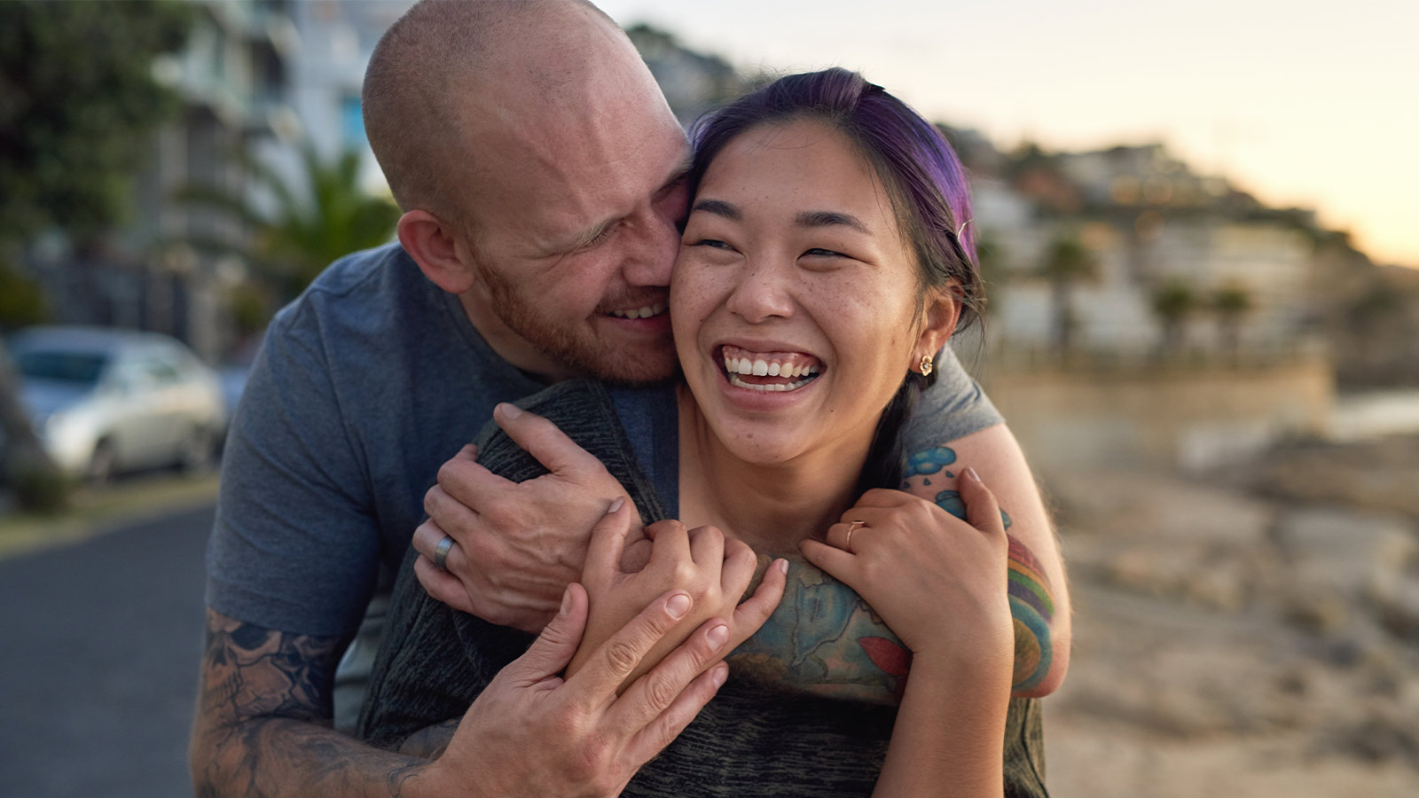 Happy couple embracing on beach.