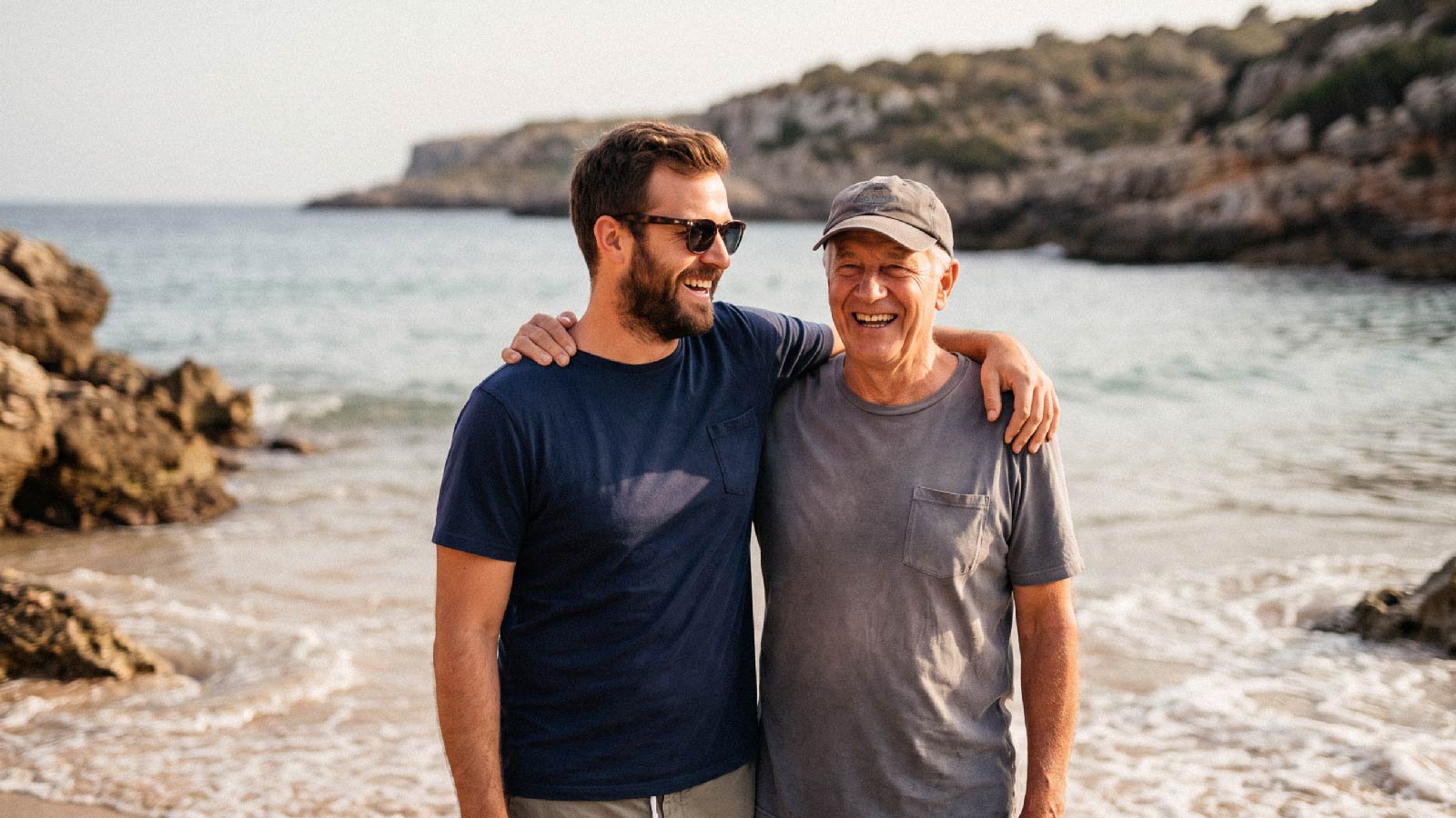 A father and son in eachothers arms at the beach.