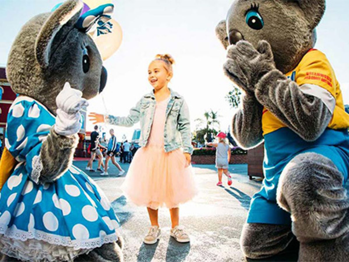 Young girl interacting with characters at Dreamworld.