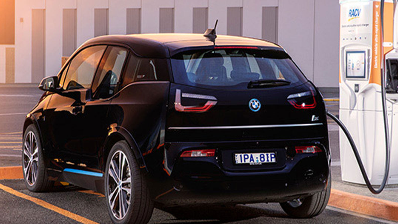 Black electric vehicle charging at an RACV chargefox station.