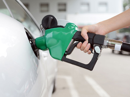 Person filling up car at a petrol station.